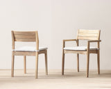 Outdoor dining chair and armchair with cushion on a wooden floor against a plain wall