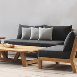 Gray sofa with wooden frame and matching coffee table on a light wooden floor.