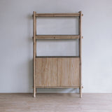 Reclaimed pine wood tall cabinet against a plain wall with a light gray color scheme.
