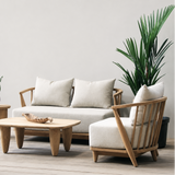 Outdoor wooden sofa set with white cushion on a wooden floor against a plain wall