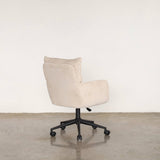 Beige office chair with black wheels on a light stone floor and white wall background