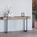 Massive Console Table with decorative items on top of it.