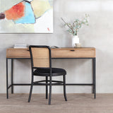 Back side of Moi Dining Chair with industrial-styled desk in front of it.