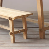 Wooden outdoor bench and dining table set on a wooden floor