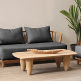 Outdoor furniture set with gray cushions and wooden frames on a wooden deck.