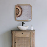 Squoval bathroom mirror with vanity  cabinet and sink in a minimalistic setting.