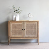 Wooden cabinet with rattan doors in a minimalistic room