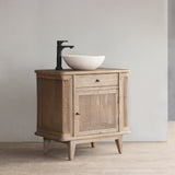 Reclaimed pine wood vanity cabinet with rattan drawer and white basin on a gray background