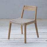 Wooden chair with woven seat on a wooden floor