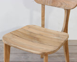 Outdoor wooden chair with rounded seat on a wooden floor against a plain wall
