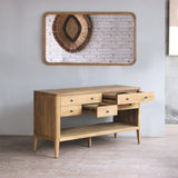 Wooden bathroom vanity in a room with a mirror on the wall.