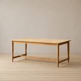 A reclaimed teak wood dining table on a wooden floor.
