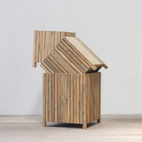 Wooden planter box set on a wooden floor against a plain wall