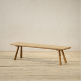 Wooden outdoor bench on a wooden floor with a plain background