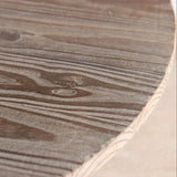 Close-up of a reclaimed pine wood table surface with visible grain and texture
