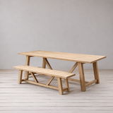 Wooden dining table and bench on a wooden floor.