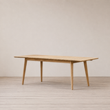 Outdoor extended table with slatted top on a wooden floor against a plain wall