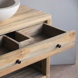 Wooden vanity with a white sink on top and an open drawer.