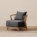 Modern sofa with wooden frame and black cushion on a wooden floor.