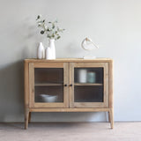 Wooden cabinet with glass doors in a minimalistic room