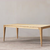 Outdoor dining table with slatted top on a wooden floor.