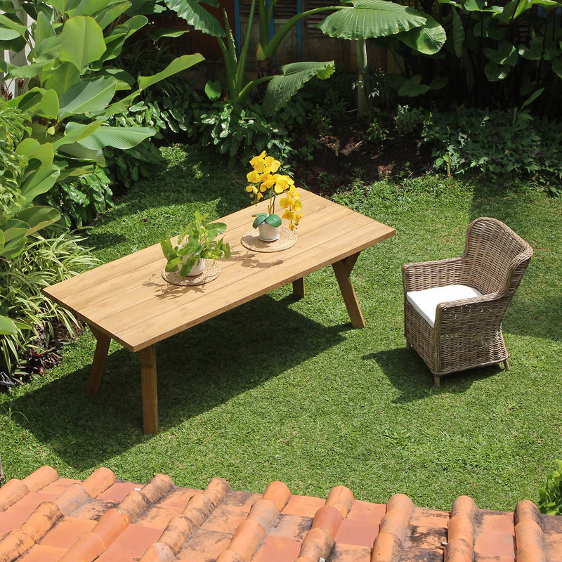 Aimann Kubu Chair being set outdoor next to Scandinavian Outdoor Table shot from above.