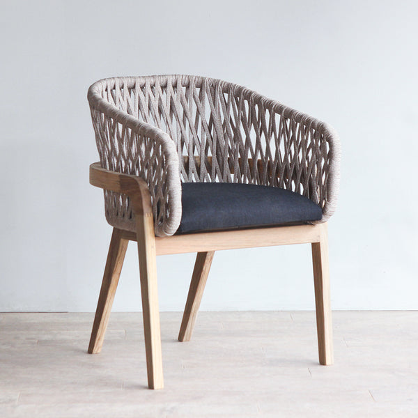 Arch dining chair. With woven rope as the backrest and teak wood as theframe.