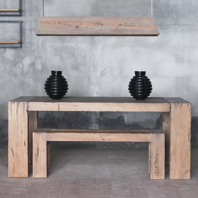 Dovetail Dining Table and Bench with two black ceramic vase on top of it.