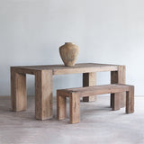 Dovetail Dining Table paired with Dovetail Bench with a vase on top of the table.