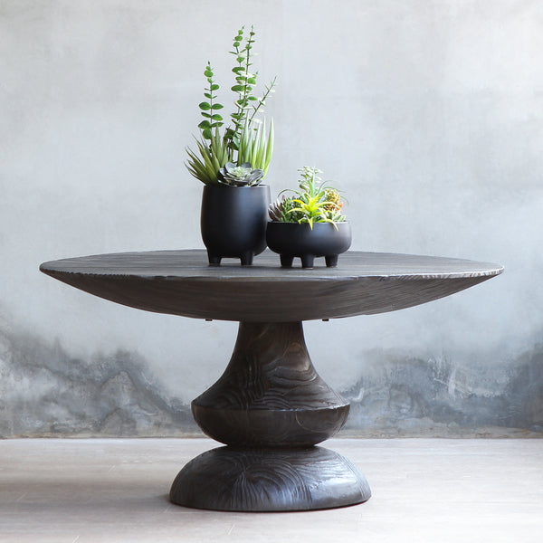Bali Coffee Table with two potted plants on top of it.