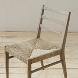 Wooden chair with woven seat on a wooden floor