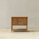 Wooden cabinet on a wooden floor with a plain wall background
