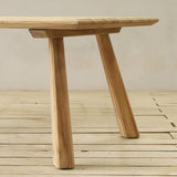 Wooden outdoor table on a wooden floor with a neutral background