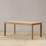 Wooden table on a wooden floor with a plain wall background