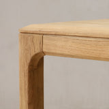 Wooden dining table with a plain background