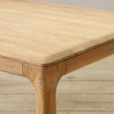 Wooden table on a wooden floor with a neutral background