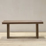 Reclaimed pine wood table on a wooden floor with a plain wall background