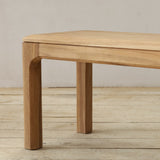 Wooden bench on a wooden floor with a neutral background