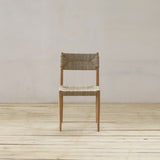 Wooden chair on a wooden floor with a white wall background