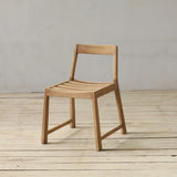 Wooden chair on a wooden floor with a plain background