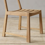 Wooden chair on a wooden floor with a neutral background