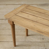 Wooden bench with a slatted top on a wooden floor