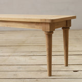 Wooden bench on a wooden floor with a neutral background