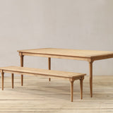 Wooden outdoor dining table and bench set on a wooden floor.