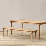 Wooden outdoor dining table and bench set on a wooden floor.