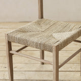 Wooden chair with woven seat on a wooden floor