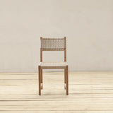 Wooden chair with woven seat and backrest on a wooden floor against a plain wall.