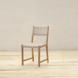 Chair with woven backrest on a wooden floor and light gray wall background