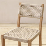 Woven chair on a wooden floor with a neutral background