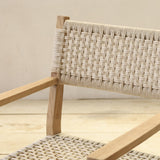 Wooden chair with woven backrest on a wooden floor.
